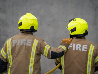 Firefighters battle blaze at shop and flats with people evacuated nearby Image