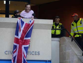 Woman who unfurled union flag from east London council building has charges against her dropped Image